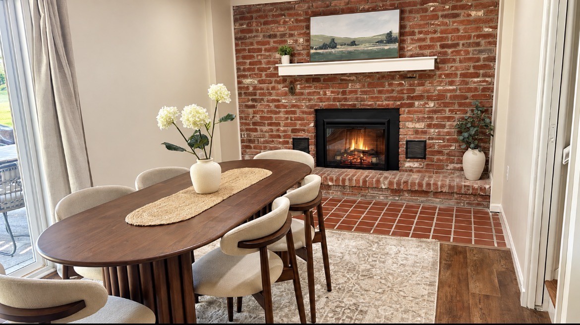 Dining table beside the brick fireplace