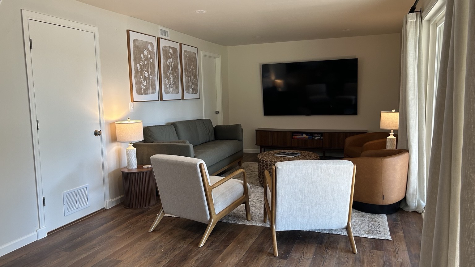 Downstairs living room with sofa, television and accent chairs