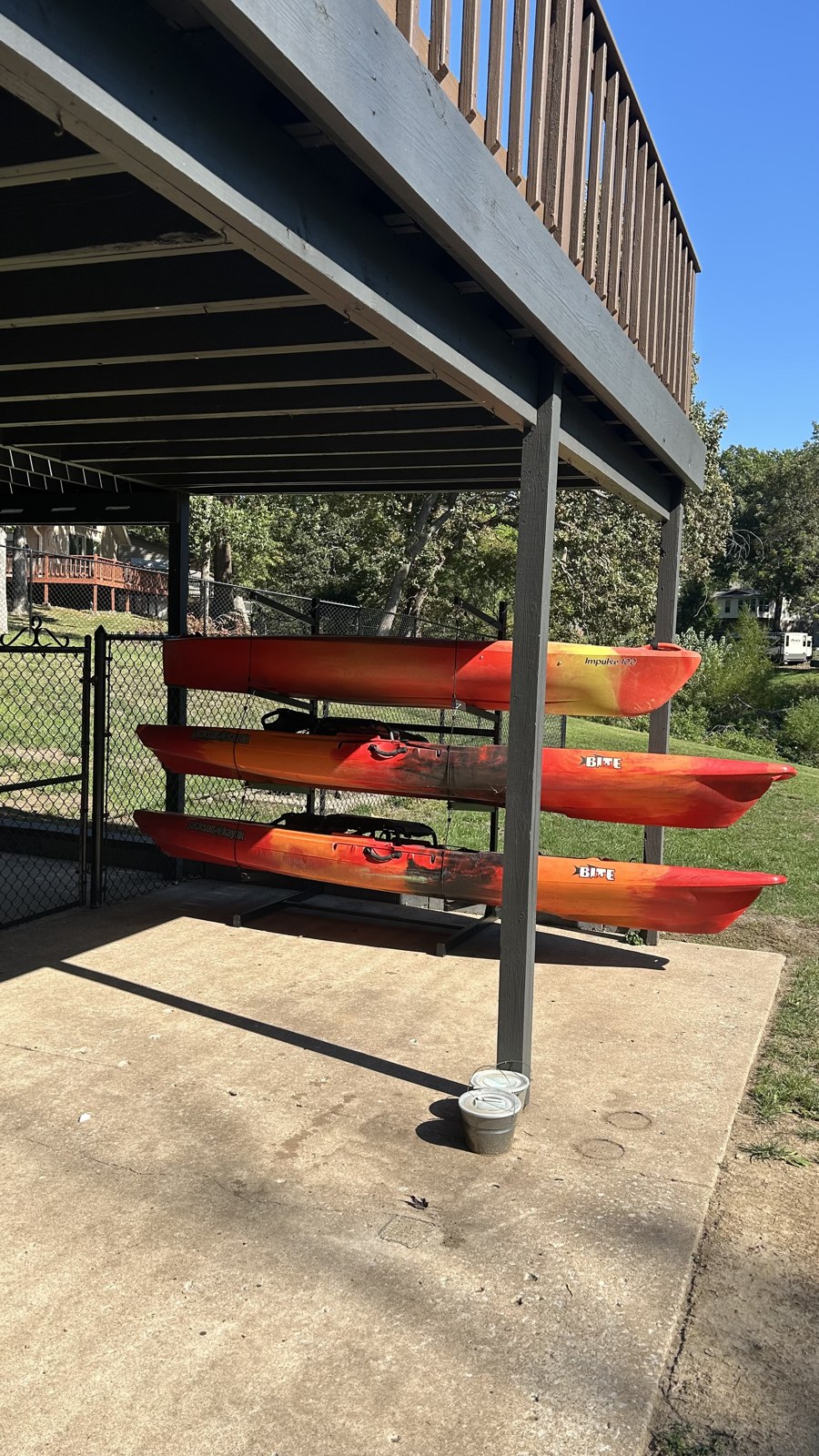 Red kayaks on the rack beneath the covered deck