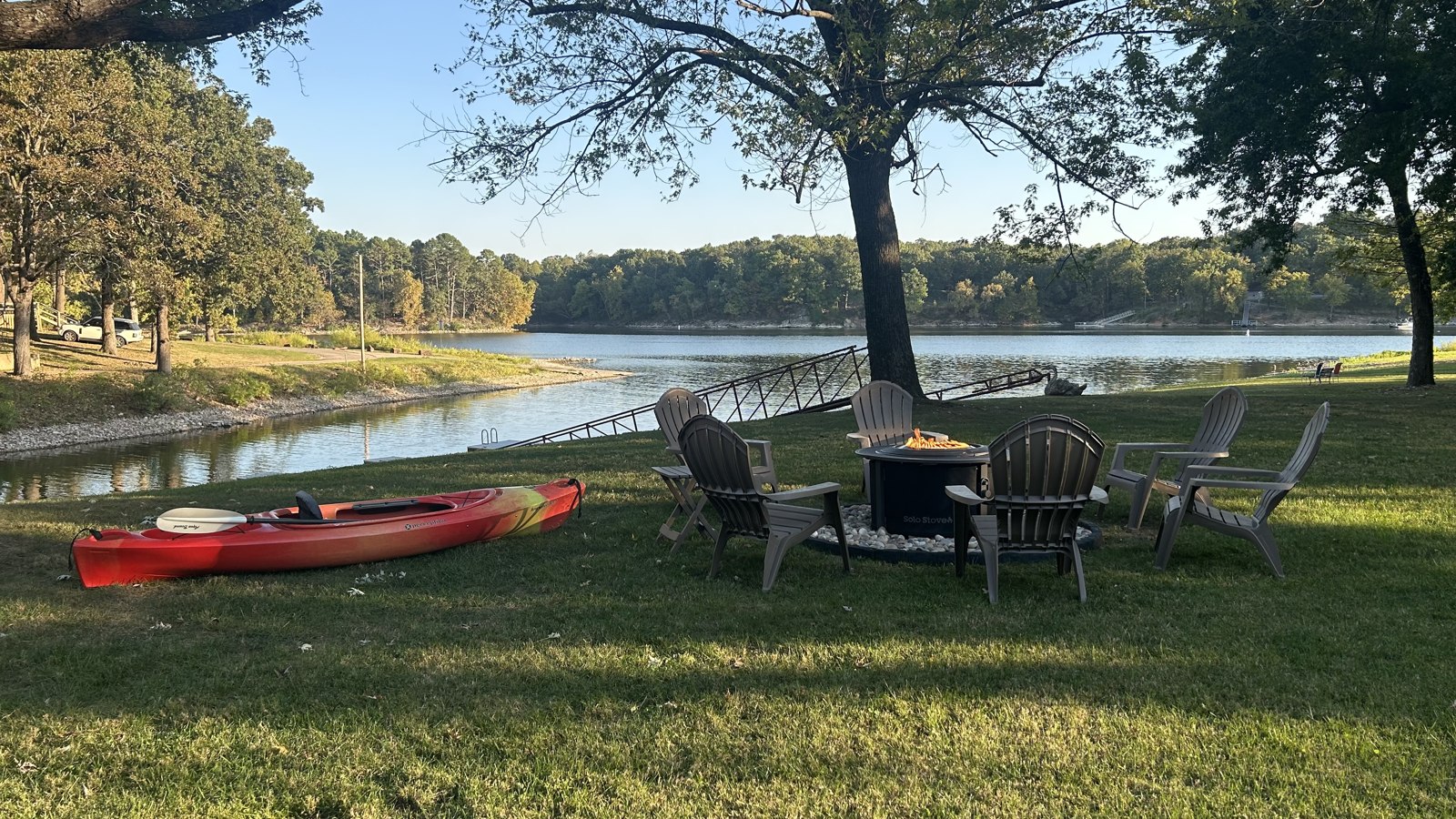 Lakefront lawn with seating, a kayak and the private dock