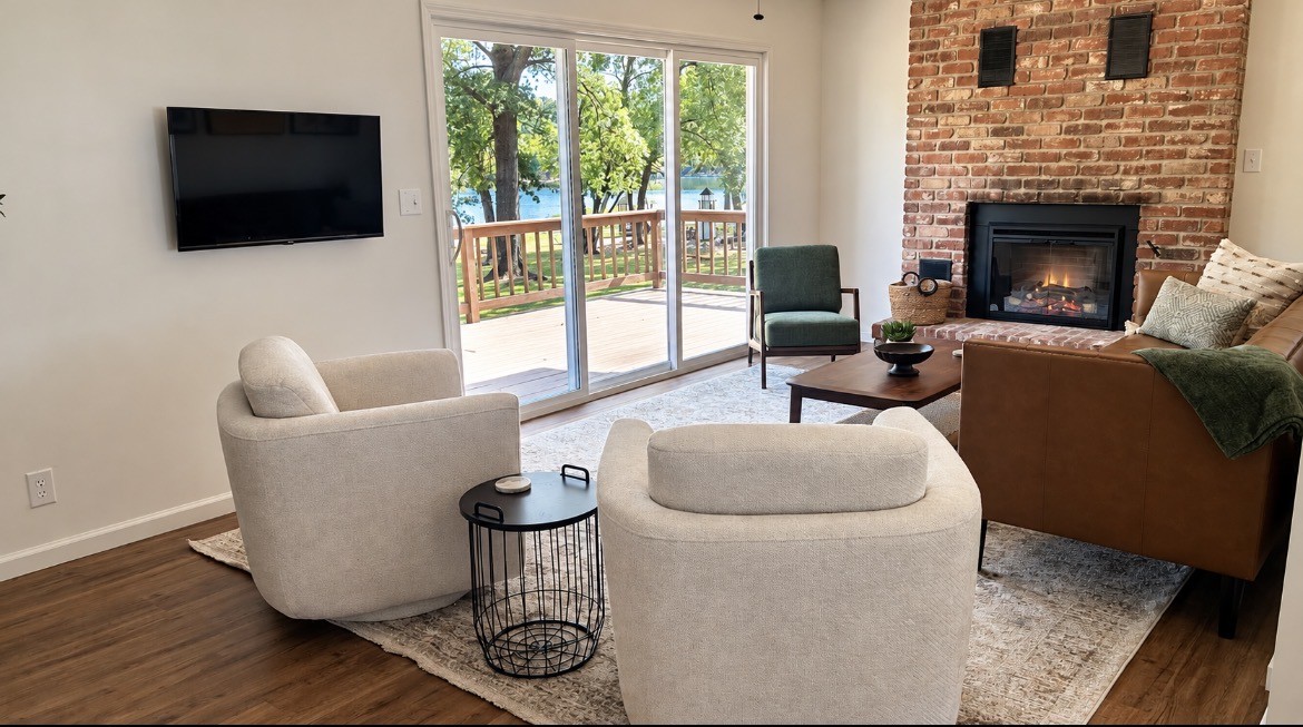 Living room with a fireplace and sliding doors overlooking Grand Lake